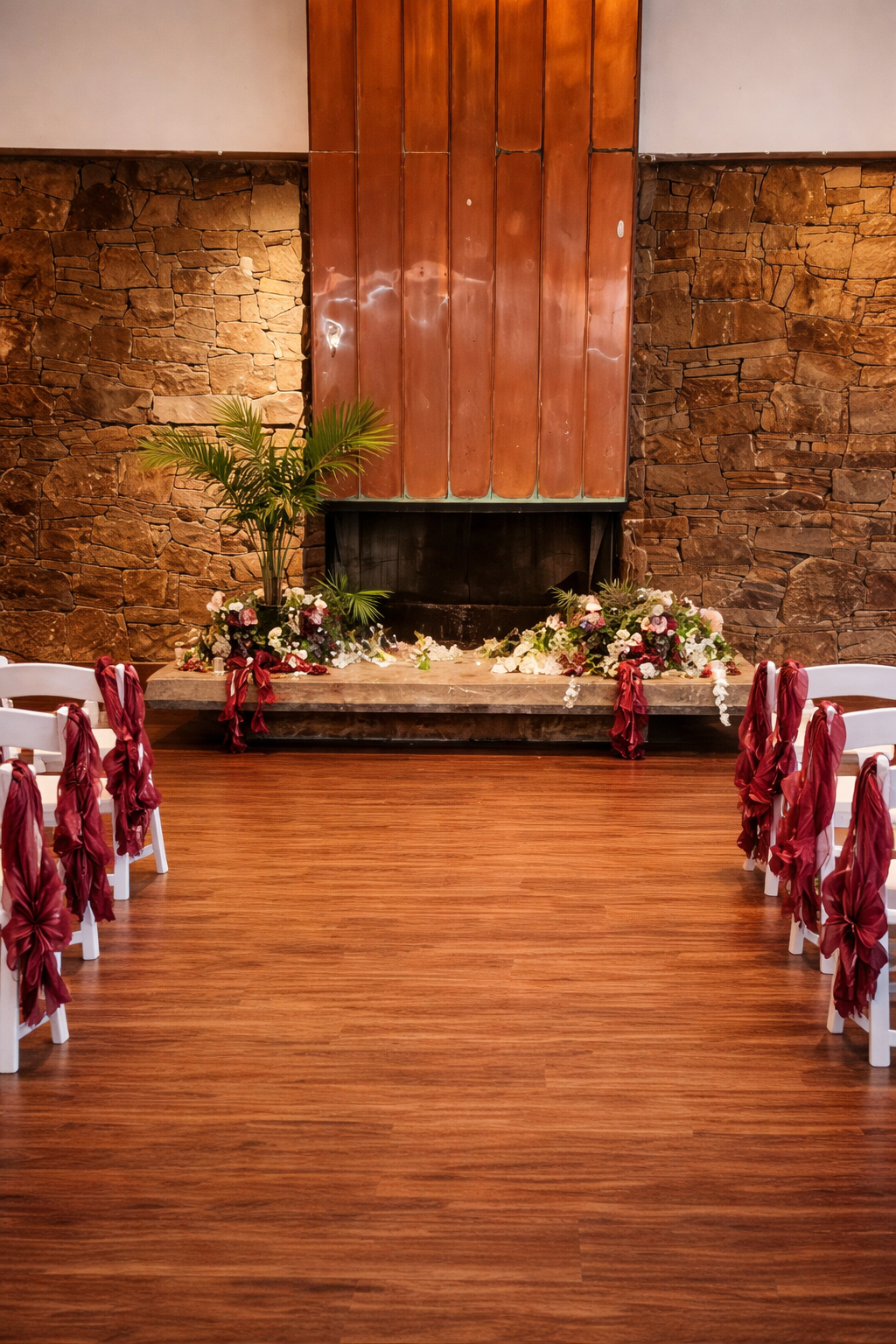 Ceremony seating arranged beside the fireplace at Oasis Grand Hall