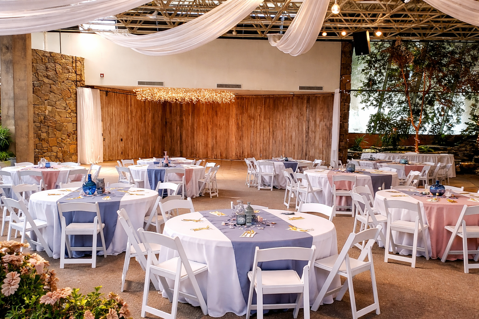Decorated event room at Oasis Grand Hall with draping and head table